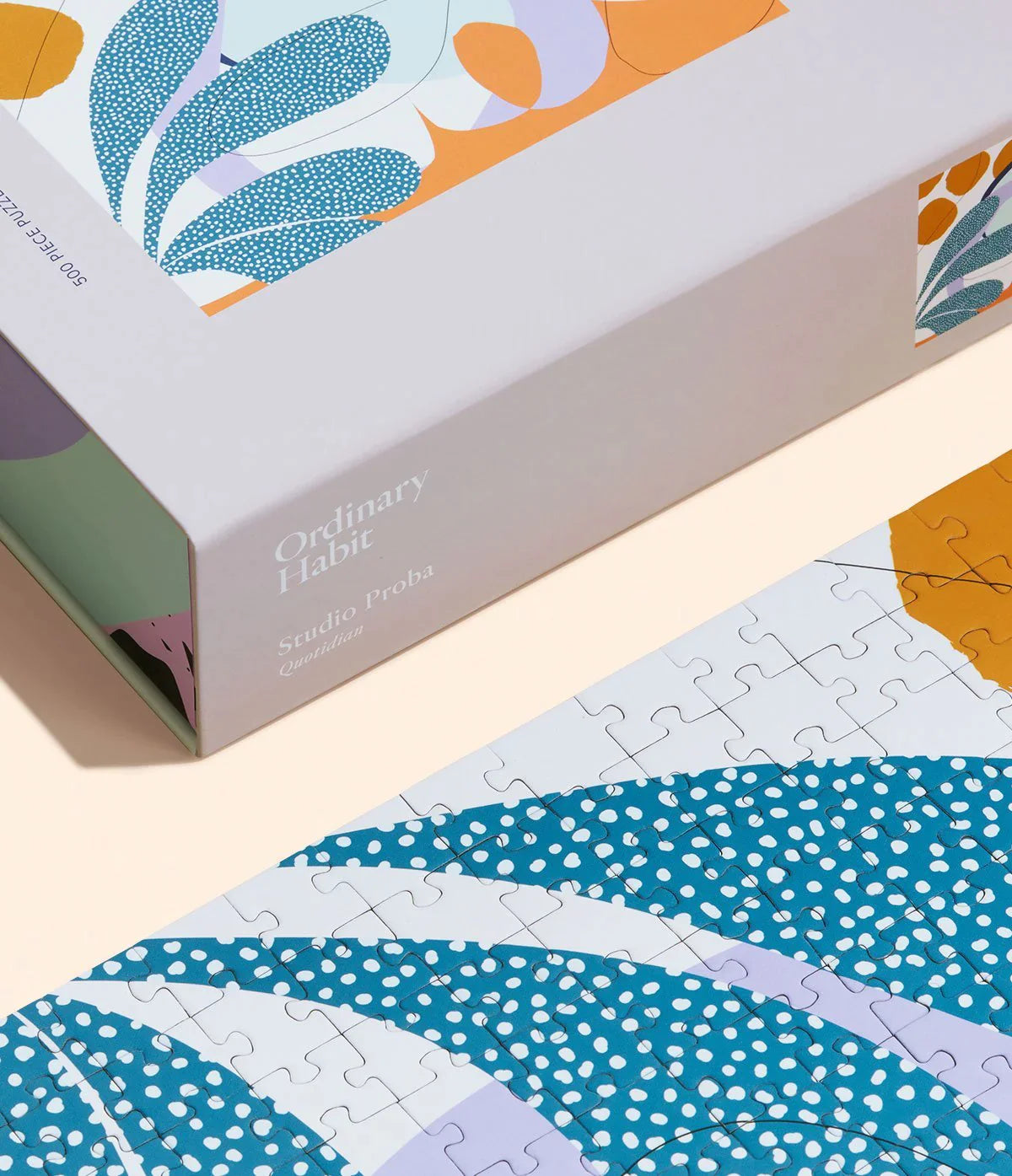Corner of the box of a 500 piece puzzle and part of the completed puzzle by Ordinary Habits representing a mindful daily ritual.