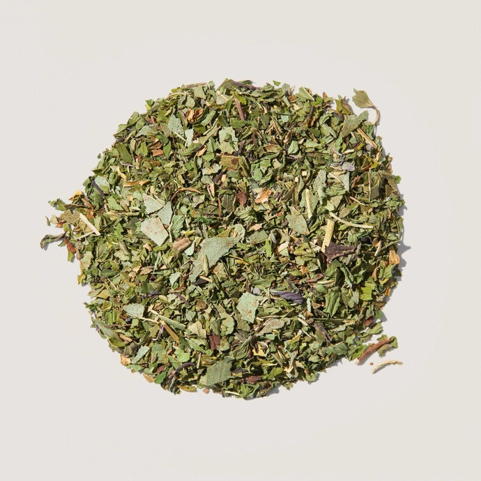 A pile of loose tea leaves of organic herbal peppermint tea.