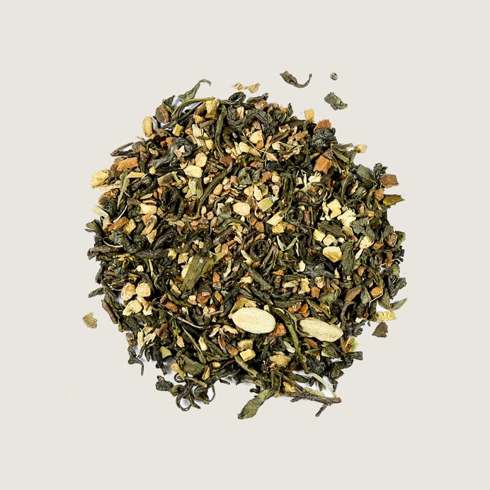 A pile of loose tea leaves of cinnamon and ginger organic green tea..