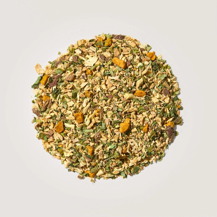 A pile of loose tea leaves of ginger and turmeric organic herbal tea.