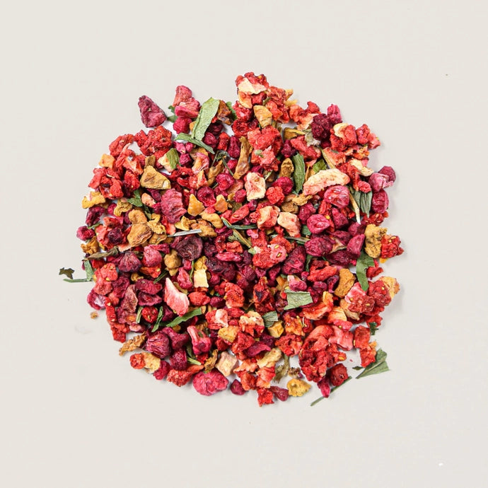 A pile of loose tea leaves of organic herbal berries and hibiscus tea.